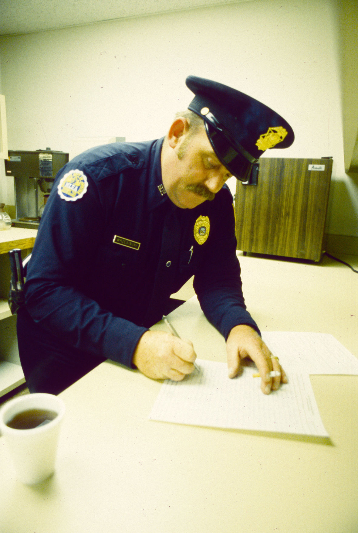 Billings police officer doing paperwork, 1987